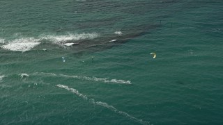 5K aerial stock footage of flying by kite surfers off the coast, Pompano Beach, Florida Aerial Stock Footage | AX0031_155