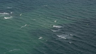 AX0031_166 - 5K aerial stock footage of passing by kite surfers, Pompano Beach, Florida