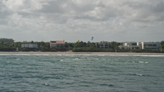 AX0031_169 - 5K aerial stock footage of flying low by kite surfers near coast, Hillsboro Beach, Florida