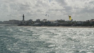 5K aerial stock footage fly by kite surfers near coast, reveal Hillsboro Inlet Light, Hillsboro Beach, Florida Aerial Stock Footage | AX0031_170E