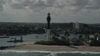 AX0031_172E - 5K aerial stock footage of orbiting the Hillsboro Inlet Light, Hillsboro Beach, Florida