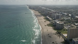 AX0031_179 - 5K aerial stock footage of following beach, approaching Pompano Beach Pier, Pompano Beach, Florida