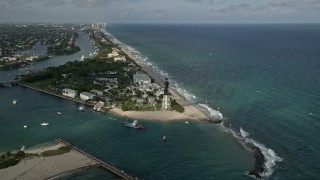 AX0032_007 - 5K aerial stock footage of approaching Hillsboro Inlet Light, tilt down over beach, Hillsboro Beach, Florida