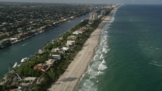 5K aerial stock footage of flying by homes near the beach, revealing coastline, Hillsboro Beach, Florida Aerial Stock Footage | AX0032_009