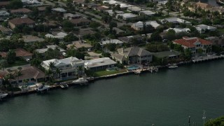 AX0032_010 - 5K aerial stock footage of flying by mansions on the bank of Intracoastal Waterway, Lighthouse Point, Florida