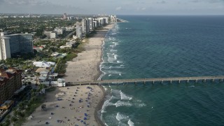 AX0032_017 - 5K aerial stock footage follow the beach, over Deerfield Beach Fishing Pier, Deerfield Beach, Florida