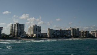 AX0032_038 - 5K aerial stock footage of flying by condominium complexes near the beach, Highland Beach, Florida