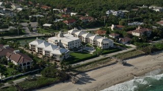 5K aerial stock footage of flying by a condominium complex by the shore, Ocean Ridge, Florida Aerial Stock Footage | AX0032_050