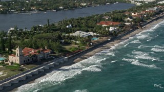 AX0032_059 - 5K aerial stock footage of flying by a coastal mansion, Manalapan, Florida