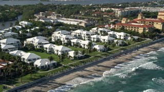 AX0032_060 - 5K aerial stock footage of flying by beachside villas, Manalapan, Florida