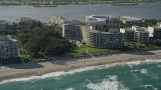 5K aerial stock footage of flying by a condominium complex on the coast, Palm Beach, Florida Aerial Stock Footage | AX0032_065