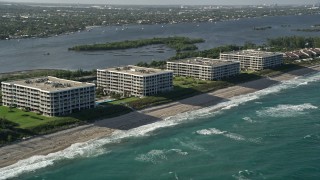 5K aerial stock footage of flying by coastal condominium complexes, Palm Beach, Florida Aerial Stock Footage | AX0032_068