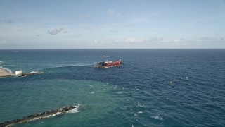 5K aerial stock footage of approaching and orbiting a dredging ship near the coast, Palm Beach Shores, Florida Aerial Stock Footage | AX0032_110E