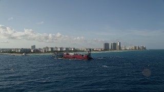 AX0032_113 - 5K aerial stock footage of flying by a dredging ship near the coast, Palm Beach Shores, Florida