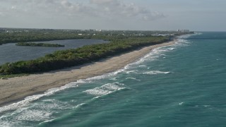 AX0032_120E - 5K aerial stock footage of John D. MacArthur Beach State Park, Riviera Beach, Florida