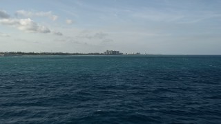 5K aerial stock footage of flying low over the Atlantic Ocean toward the coast, Jupiter, Florida Aerial Stock Footage | AX0032_133