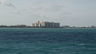 5K aerial stock footage of flying low over Atlantic Ocean near beachfront condominiums, Jupiter, Florida Aerial Stock Footage | AX0032_134