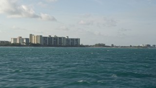 5K aerial stock footage of flying low over Atlantic Ocean near condo complexes, Jupiter, Florida Aerial Stock Footage | AX0032_135