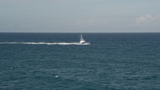 AX0032_137 - 5K aerial stock footage of tracking a fishing boat cruising across the Atlantic, Jupiter, Florida