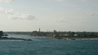 AX0032_145 - 5K aerial stock footage of flying by Jupiter Inlet, Jupiter Inlet Light, Jupiter, Florida