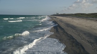 AX0032_146E - 5K aerial stock footage of flying over beach, revealing sea birds, coast, Hobe Sound, Florida