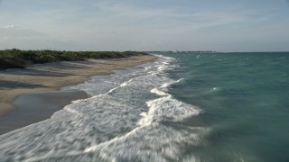 AX0032_152E - 5K aerial stock footage of flying low over the beach, Saint Lucie Inlet Preserve State Park, Stuart, Florida