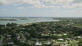 AX0033_002 - 5K aerial stock footage of flying over waterfront neighborhood toward an inlet, Stuart, Florida