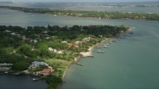 AX0033_003 - 5K aerial stock footage of fly by waterfront community and docks on an inlet, Stuart, Florida