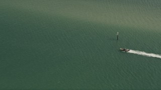 AX0033_006 - 5K aerial stock footage of tracking a speedboat cruising across the water, Indian River, Stuart, Florida