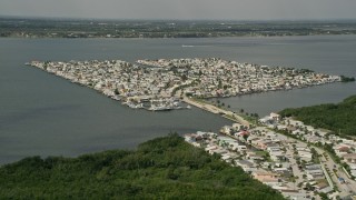 AX0033_013 - 5K aerial stock footage of houses on a waterfront island community, Nettles Island, Jensen Beach, Florida