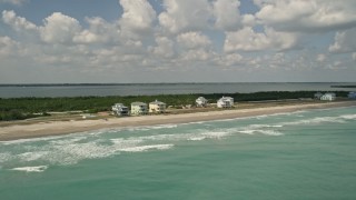 AX0033_025 - 5K aerial stock footage of beachfront homes along the blue ocean waters, Fort Pierce, Florida