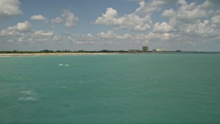 AX0033_034 - 5K aerial stock footage fly over blue waters by the beach near a coastal community, Fort Pierce, Florida