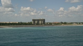 5K aerial stock footage of flying by a beachfront apartment building, Fort Pierce, Florida Aerial Stock Footage | AX0033_039