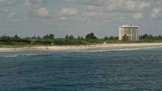 5K aerial stock footage of flying by sunbathers on the beach, Fort Pierce, Florida Aerial Stock Footage | AX0033_044