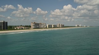 AX0033_045E - 5K aerial stock footage fly by beachfront apartment buildings, Fort Pierce, Florida