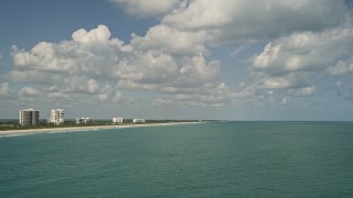 AX0033_047 - 5K aerial stock footage of flying along the coastline and over blue waters, Fort Pierce, Florida