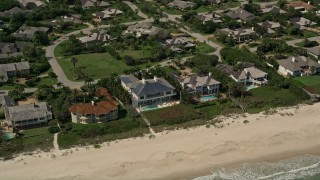 AX0033_058 - 5K aerial stock footage of orbiting away from beachside mansions, Vero Beach, Florida