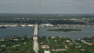 AX0033_060 - 5K aerial stock footage of flying by a bridge and power plant, Vero Beach, Florida