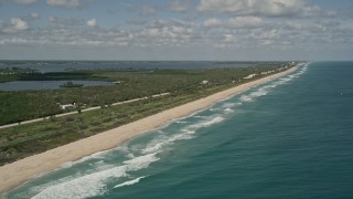 AX0033_067 - 5K aerial stock footage of following the beach and blue waters on the coast, Melbourne Beach, Florida