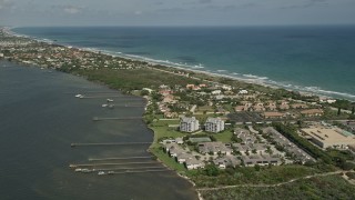 5K aerial stock footage of approaching docks and residential neighborhood on the coast, Melbourne Beach Aerial Stock Footage | AX0033_068