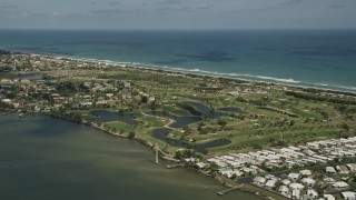 AX0033_071 - 5K aerial stock footage of a golf course by the river, Melbourne Beach, Florida