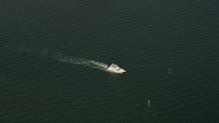 AX0033_075 - 5K aerial stock footage of tracking a fishing boat on the river, Melbourne Beach, Florida