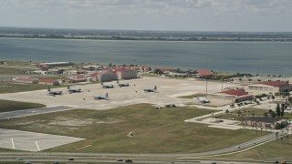 AX0034_005 - 5K aerial stock footage of parked turboprop military planes, Patrick Air Force Base, Florida