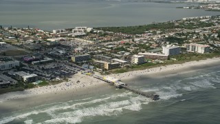 5K aerial stock footage of flying by sunbathers on the beach near the pier, Cocoa Beach, Florida Aerial Stock Footage | AX0034_010