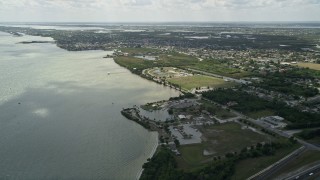 AX0034_024 - 5K aerial stock footage of flying by a community park along the river, Merritt Island, Florida