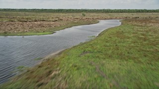 5K aerial stock footage of flying low over a river valley, Cocoa, Florida Aerial Stock Footage | AX0034_038