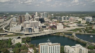 5K aerial stock footage of orbiting Lake Lucerne, approach Downtown Orlando and the Expressway, Florida Aerial Stock Footage | AX0034_092E