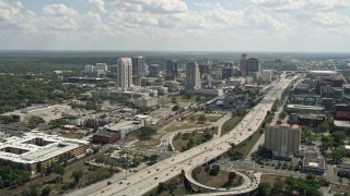 AX0034_098E - 5K aerial stock footage of a wide view of Interstate 4 and Downtown Orlando, Florida