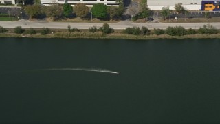 5K aerial stock footage of tracking a toy speedboat racing around in a pond, Orlando, Florida Aerial Stock Footage | AX0035_010E