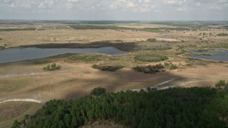 5K aerial stock footage of approaching small lakes and farmland, Clermont, Florida Aerial Stock Footage | AX0035_088E